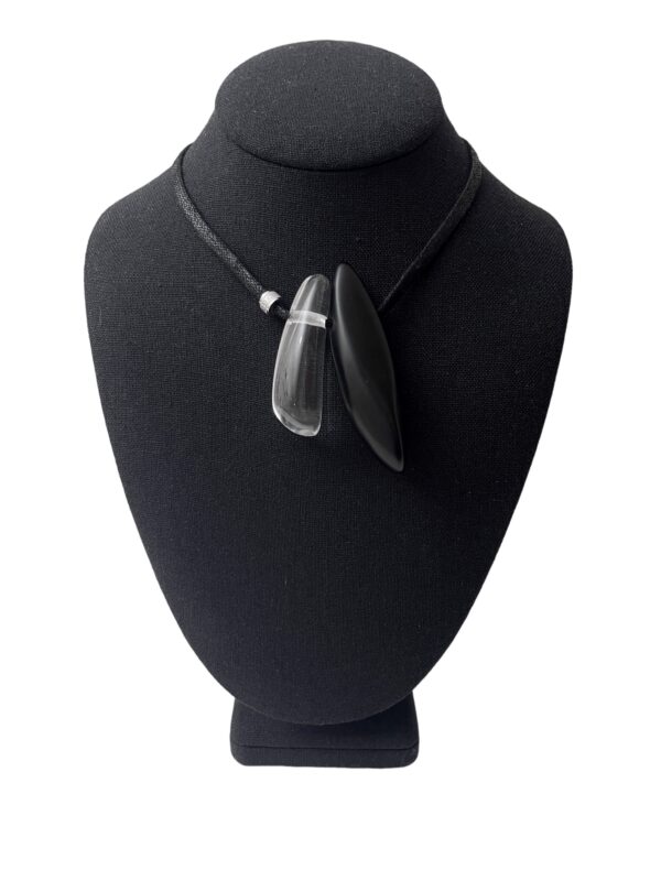 A simple but elegant black color cotton cord with one black matte resin pendant and one clear resin pendant.  The perfect look for the minimalist to make an impression.  The necklace is adjustable, and you can wear it as a choker or as long as 29 IN.  Lightweight and easy to travel. 