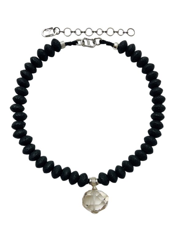 This unique natural necklace combines the texture of porous lava stone with a dense polished crystal. The necklace measures 20 IN/4 OZ and can extend up to 24 IN. In the mystical world, lava stone is used for pain management.