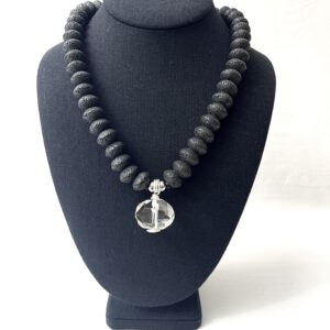 This unique natural necklace combines the texture of porous lava stone with a dense polished crystal. The necklace measures 20 IN/4 OZ and can extend up to 24 IN. In the mystical world, lava stone is used for pain management.