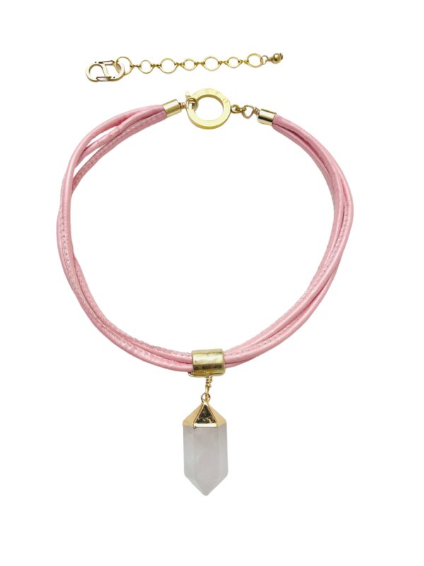 The necklace is a minimalist-style single Crystal pendant on multiple strands of light pink vegan leather cord. The light pink color of the cord, combined with the white crystal, creates a soft effect in a modern style. The necklace measures 19 IN/2 OZ and includes an extender to make it up to 22 IN long.