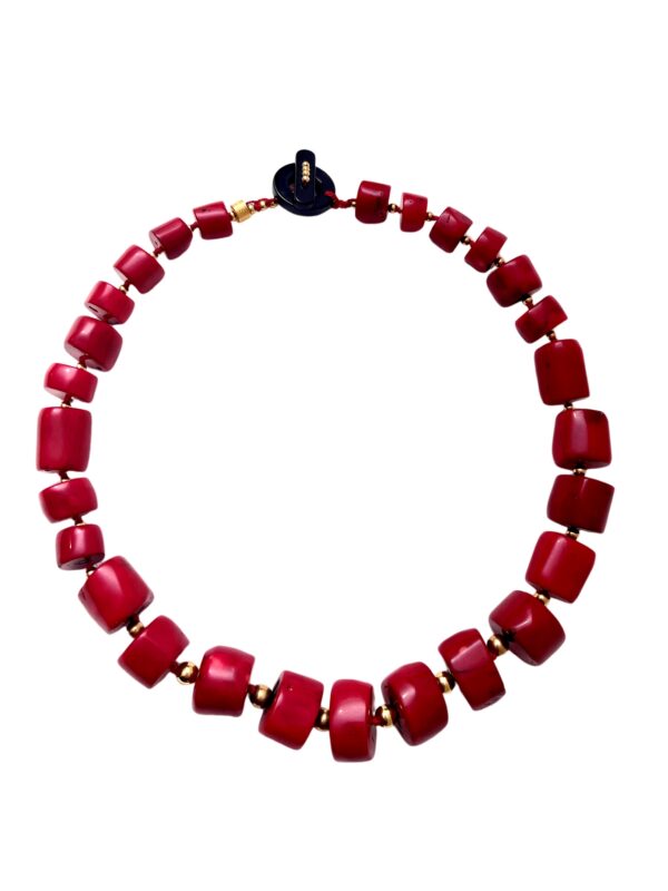 The necklace is a stunning display of natural deep red polished Coral beads in cylindrical shapes with a black stone toggle clasp. It measures 24 IN/11 OZ and is a true red, a little dressy and casual. The necklace is handcrafted, eye-catching, and timeless.