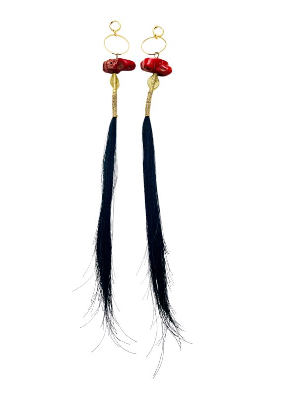 This pair of earrings is designed for those with long hair.  It is a playful combination of tassels, Coral, and Brass. The tassels are cut unevenly to mimic the natural shape of piggytails. The earrings are made of natural red coral with brass accent beads. They measure 12 IN/2 OZ.