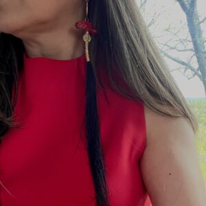 This pair of earrings is designed for those with long hair.  It is a playful combination of tassels, Coral, and Brass. The tassels are cut unevenly to mimic the natural shape of piggytails. The earrings are made of natural red coral with brass accent beads. They measure 12 IN/2 OZ.