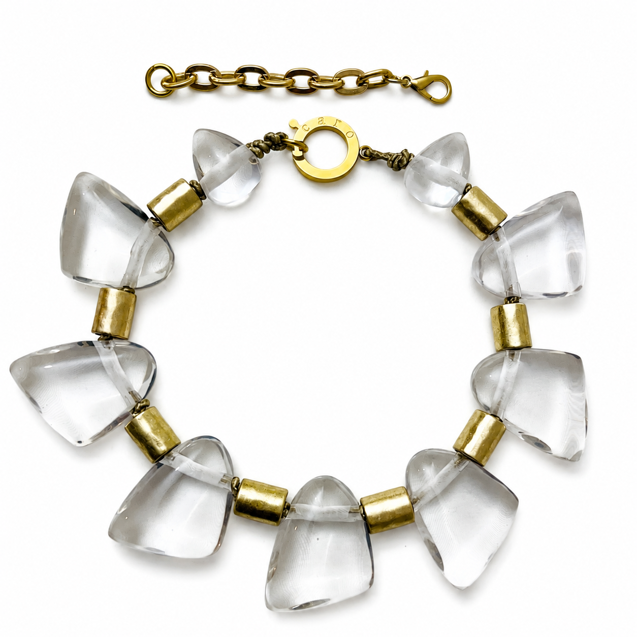 Statement necklace featuring large translucent resin beads shaped like tapered cones, alternating with cylindrical gold spacers. The design is completed with a gold clasp and extender chain, creating a modern, sculptural look.