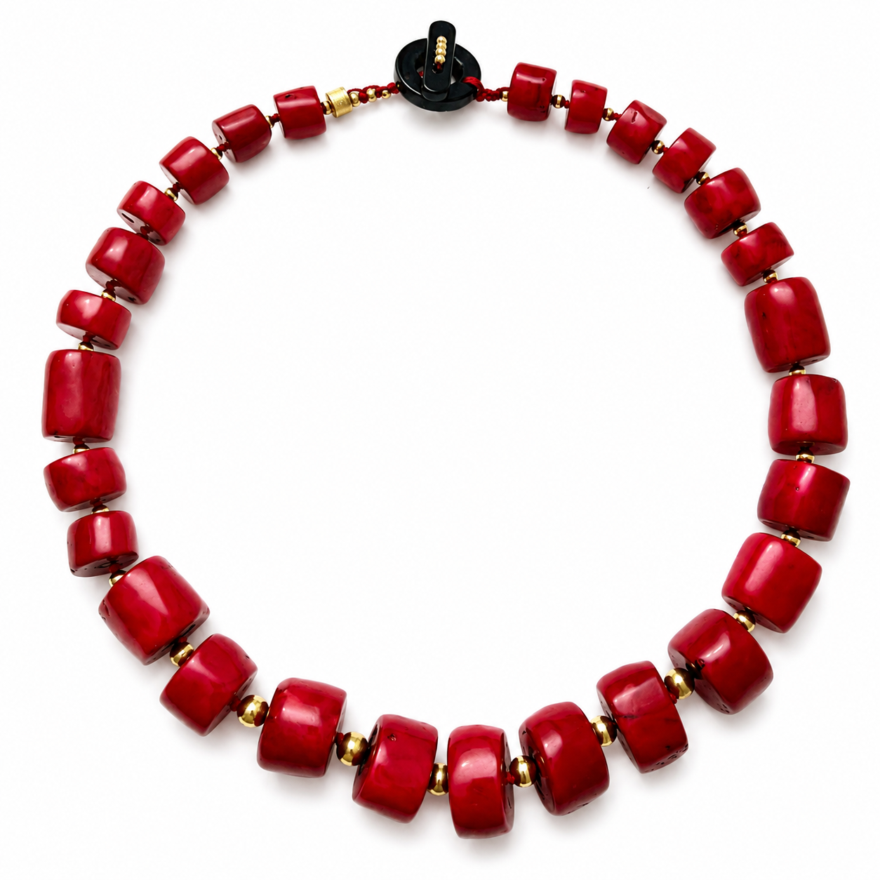 Necklace composed of polished red coral beads in cylindrical shapes, separated by small gold spacers. The design forms a continuous loop with a black toggle clasp featuring gold detailing.