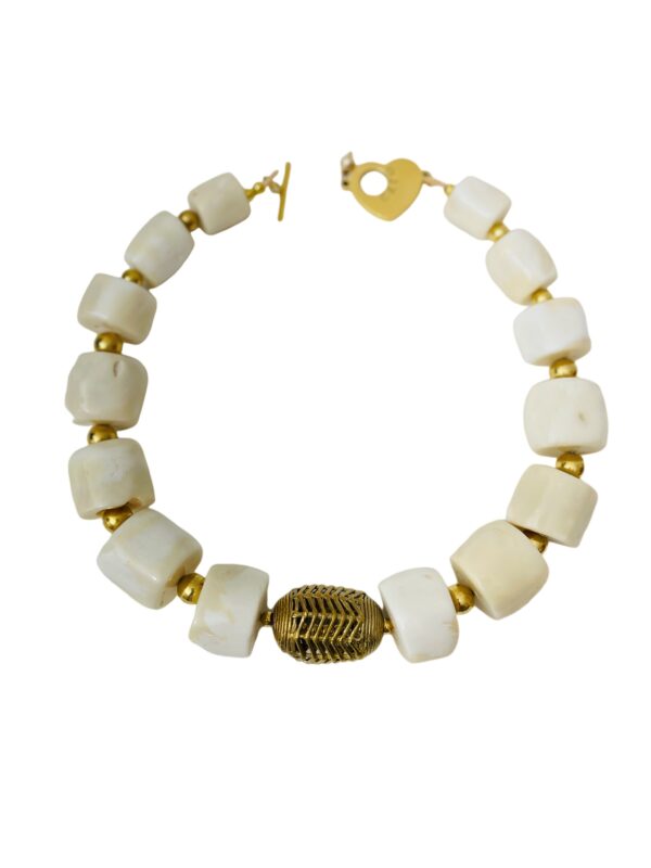Natural white Coral in wheel-shaped large beads.  A design that screams exotic, displaying the natural color of the Coral.  The necklace measures 19 IN/13OZ.  