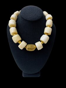 Natural white Coral in wheel-shaped large beads.  A design that screams exotic, displaying the natural color of the Coral.  The necklace measures 19 IN/13OZ.  