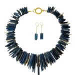 Natural Kyanite can be blue, green, bluish-green, black, or orange.  Most Kyanite is translucent and a bit delicate.   Kyanite forms sedimentary rocks that undergo a metamorphosis that changes the composition of the minerals in clay.  The formation of Kyanite looks like blades of crystals visible in the beads of this necklace.  Kyanite exists in Myanmar, Cambodia, Kenya, Nepal, Tibet, Brazil, Switzerland, Russia, and the USA.  The necklace is elegant but still displays the natural wonders of the stone in its simplest form.  It measures 19 inches/12 ounces and includes matching earrings 2.5-inch long.