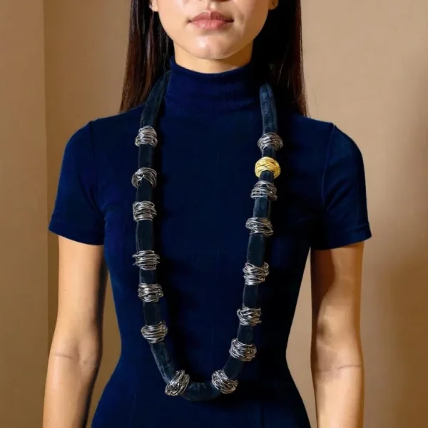 🖤 Sleek, sculptural, and full of possibility—the Knotty Long Necklace is designed for those who gravitate toward texture-rich styling and customizable elegance. Measuring 44 inches and weighing 16 ounces, this versatile piece offers a generous canvas for creative expression. Its elongated form can be worn in a single dramatic line or doubled for a fuller, collar-like silhouette. Wired beads run along the black cord in a flexible layout that responds to your mood: leave them spaced for fluid minimalism or gather them to create clustered statements. This interplay between open space and deliberate grouping lends the design a subtle, knotty sophistication—structured yet organic, playful yet poised. The necklace’s name hints at the artistry behind its creation. Each arrangement carries a knotty visual rhythm, drawing the eye to moments of tension and release, echoing the curves and coils found in nature or hand-sculpted form. It’s more than just accessory—it’s composition in motion. Ideal for the creative dresser, it transitions seamlessly from gallery nights to weekend escapes. The Knotty Long Necklace doesn’t follow rules—it rewrites them, embracing complexity, personality, and expressive layering. Style it loose. Style it close. Either way, it becomes part of your narrative.