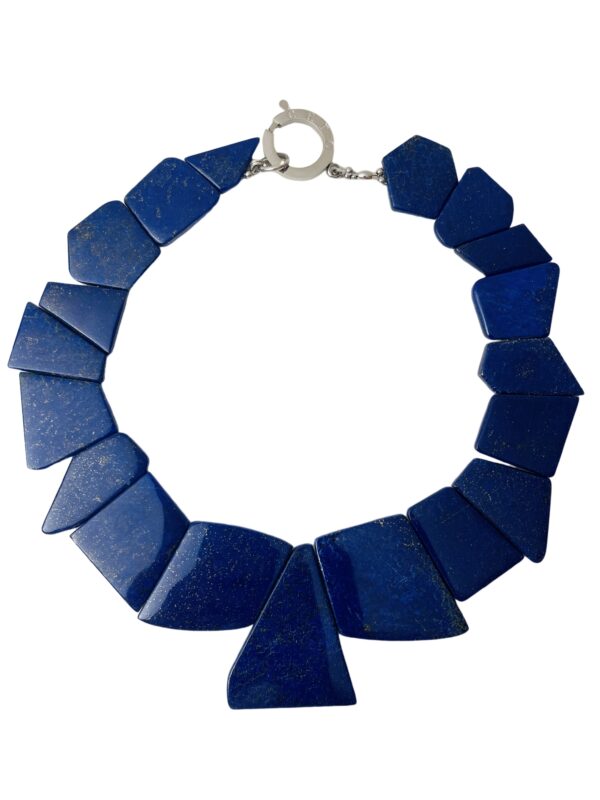 This is a large-cut, polished, irregular-shaped genuine natural stone Lapis Lazuli. The necklace measures 17 IN/7 OZ.  The center bead measures 2 IN.