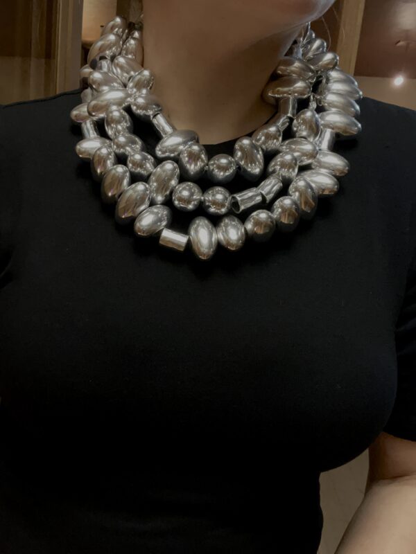 Sophisticated and elegant display of silver oval-shaped beads. You can wear the necklace with casual or formal attire in one, two, or even three strands. The necklace necklace measures 65 IN/20 OZ. The necklace will show extra cord to make the neck curve if you wear it in multiple layers.