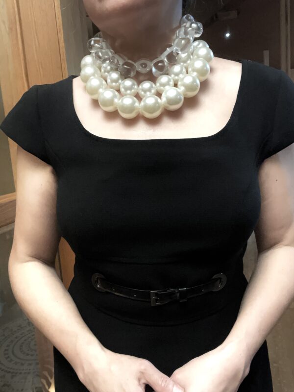 A set of 2 strands of medium-sized simulation pearls, with a separate choker necklace of one clear resin, tooth-shaped clear beads. You can wear the set or wear one or the other. The clear beads necklace contrasts the pearls' formality but also brings out the shine of the beads. The combination of styles is a unique statement for day or night. The necklace includes an extension to elongate both necklaces as a set or only one. This item sells as a set. The clear beads choker measures 16 IN/5 OZ. The double-strand necklace measures 17 IN/ 10 OZ Extension up to 5 IN A set 16 IN/15 OZ