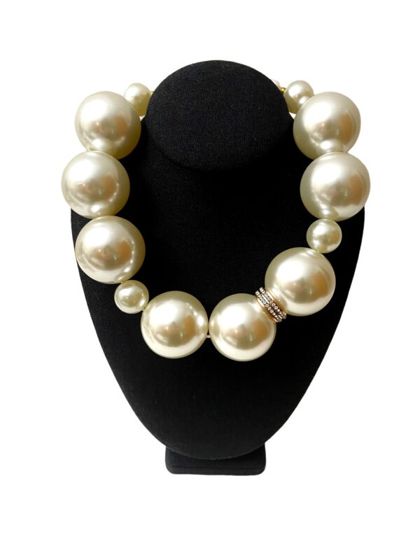 Statement necklace of oversized simulation pearls. A distinctive look with a one-of-a-kind choker necklace. The size of the beads makes the necklace elegant for night-time and fun for day-time. The necklace measures 20 IN/10 OZ.