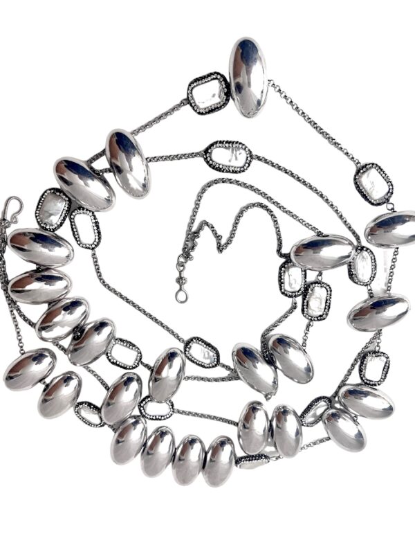 This elegant two-strand chain necklace features large oval metal beads, fresh water pearls with Rhinestone accent beads. Its intricate design makes you do a double take. The necklace measures 20 IN/8 OZ.