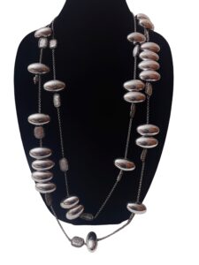 This elegant two-strand chain necklace features large oval metal beads, fresh water pearls with Rhinestone accent beads. Its intricate design makes you do a double take. The necklace measures 20 IN/8 OZ.