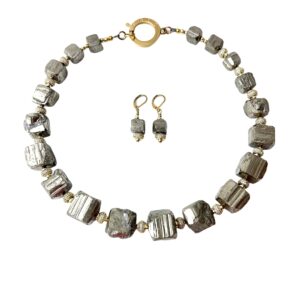 Natural unpolished Pyrite crystals with Zirconia and gold-plated spacer beads. The color is gray platinum, measuring 20 IN/10 OZ. This is a set with the earring of the same materials. The stones have the natural formation of the Pyrite minerals.