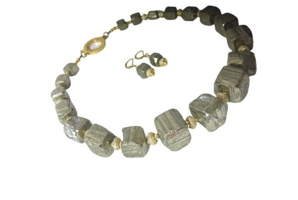 Natural unpolished Pyrite crystals with Zirconia and gold-plated spacer beads. The color is gray platinum, measuring 20 IN/10 OZ. This is a set with the earring of the same materials. The stones have the natural formation of the Pyrite minerals.