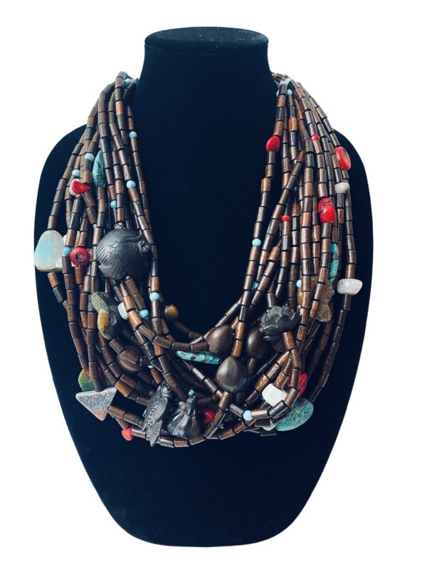 Wood, Agate, Coral, Peach Wood, Conch fossil, Kukui, sea sediment, and Amazonite.  A blend of beads.  The shortest strand is 26 IN, and the longest is 31 IN.  Total weight 14OZ