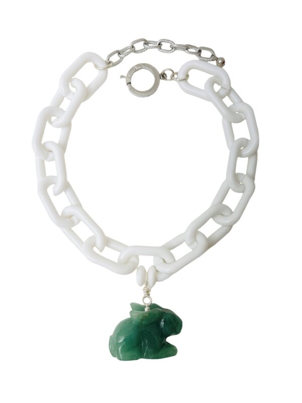 White acrylic chain link and natural Aventurine bunny. The necklace measures 17/20IN/3OZ. You can wear it short at 17 inches or longer at 20 inches.