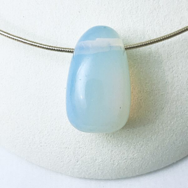 Opalite: A translucent to milky stone made of iridescent glass.  The stone is believed to help with depression, but what is more impressive is the way it captures the light.  The stone picks up the colors around it, and it is difficult to identify it with a specific color. 