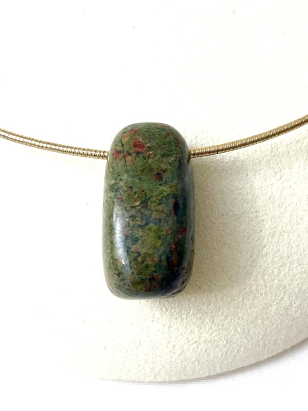 Unakite: A rich green stone with specks of red.  Unakite is a healing and alternative medicine stone. Its unique minerals are believed to promote emotional and spiritual healing.