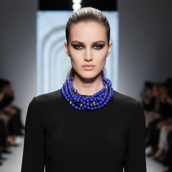 A cobalt blue statement in modern refinement, this striking beaded necklace is designed to captivate and impress. Its bold silhouette rests comfortably around the neck, making it effortlessly wearable for day or night occasions. At its core, the design pairs deep navy silicone beads with luminous gold accents, marrying softness and shine in a harmonious melody. Crafted with intention, the beads are meticulously strung to balance weight and flow, ensuring the piece catches light at every turn. The rich hue—evocative of the most vibrant oceanic depths—imbues the necklace with an air of mystery and allure. Accented by gold beads, the composition achieves a timeless elegance that elevates any ensemble. Perfect for those who dare to stand out, this necklace transforms simple outfits into gallery-ready statements. Whether layered over a crisp white blouse or contrasted against an evening gown, its dynamic color palette commands attention without overwhelming. The warm gleam of gold accents dances across the deep backdrop, creating a visually unforgettable moment. Versatile yet singular in appeal, this accessory is the epitome of graceful boldness. Let it be the focal point of your look, a conversation starter, and a symbol of confident style. In every setting, this dramatic necklace promises to turn heads and evoke admiration.