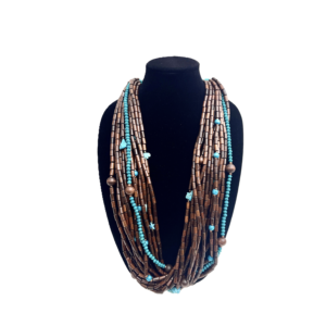 This exquisite multi-strand necklace is practical in every sense, seamlessly blending style and functionality. Handcrafted with care, it features polished wooden beads that showcase their warm, natural tones alongside vibrant turquoise accents that inject a burst of color into any look. The combination creates a striking visual appeal that feels both grounded and fresh. Measuring 38 inches when worn as a single strand, the necklace hangs gracefully, draping around the neck in elegant layers. Its versatile horseshoe clasp design offers a practical way for styling options, allowing you to double it up into a chic choker for a completely different vibe. This duality makes the piece practical for everyday wear and ideal for special occasions alike. Each bead is meticulously chosen to ensure uniformity in shape and color, resulting in a harmonious flow that highlights the contrast between deep wood grains and the bright turquoise hue. The horseshoe clasp, with its smooth curves and secure closure, adds a refined touch, reinforcing the necklace’s blend of artisanal craftsmanship and modern sensibility. Whether you’re dressing up a simple blouse or accentuating a formal gown, this statement necklace elevates your ensemble with ease. It’s the perfect accessory for those who appreciate adaptive design and enduring beauty.