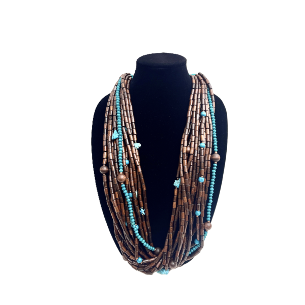 This exquisite multi-strand necklace is practical in every sense, seamlessly blending style and functionality. Handcrafted with care, it features polished wooden beads that showcase their warm, natural tones alongside vibrant turquoise accents that inject a burst of color into any look. The combination creates a striking visual appeal that feels both grounded and fresh. Measuring 38 inches when worn as a single strand, the necklace hangs gracefully, draping around the neck in elegant layers. Its versatile horseshoe clasp design offers a practical way for styling options, allowing you to double it up into a chic choker for a completely different vibe. This duality makes the piece practical for everyday wear and ideal for special occasions alike. Each bead is meticulously chosen to ensure uniformity in shape and color, resulting in a harmonious flow that highlights the contrast between deep wood grains and the bright turquoise hue. The horseshoe clasp, with its smooth curves and secure closure, adds a refined touch, reinforcing the necklace’s blend of artisanal craftsmanship and modern sensibility. Whether you’re dressing up a simple blouse or accentuating a formal gown, this statement necklace elevates your ensemble with ease. It’s the perfect accessory for those who appreciate adaptive design and enduring beauty.