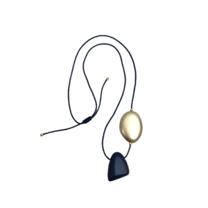 A striking black and gold necklace blends bold elegance with versatile styling, making it the perfect companion for modern life. Featuring two large beads—one fixed, one adjustable—this piece invites personal expression for any event, day or night. The streamlined aesthetic highlights the dynamic contrast between deep ebony and luminous gold, offering an eye-catching accent that never feels over the top. With its innovative adjustable cord, this necklace can be worn at multiple lengths—from a dramatic 44-inch drop to a more reserved mid-length or a snug choker. The flexible design ensures effortless transitions between looks, while the lightweight construction (under 2 ounces) guarantees comfort during travel and everyday wear. Each bead slides smoothly along the cord, allowing you to shift and restyle with ease. Embodying minimalist refinement, this accessory is the epitome of form meeting function. Whether layered over a crisp white shirt or paired with evening attire, its adaptable silhouette and timeless color palette enhance any outfit. The minimalist style underscores the uncluttered design at its core, while the third highlights its ability to make a statement without excess. Perfect for those who value simplicity, versatility, and enduring style, this necklace transforms even the simplest ensemble into a sophisticated statement. Its minimalist design ensures it remains a cherished heirloom.
