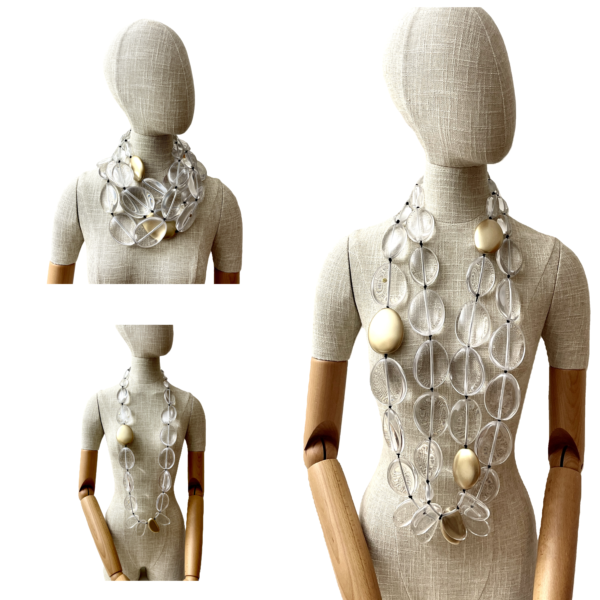 This exquisite, extra-long necklace features a stunning combination of clear beads interspersed with elegant gold accent beads, creating a sophisticated and eye-catching accessory. The harmonious blend of clear and gold tones adds a touch of luxury.  
