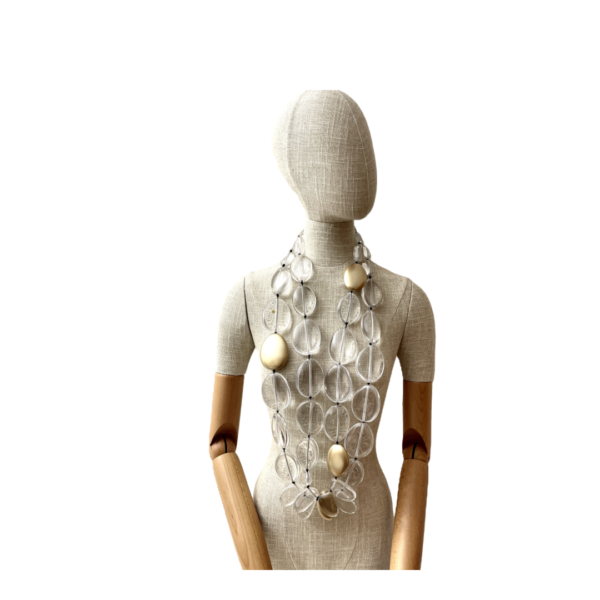 This exquisite, extra-long necklace features a stunning combination of clear beads interspersed with elegant gold accent beads, creating a sophisticated and eye-catching accessory. The harmonious blend of clear and gold tones adds a touch of luxury.  