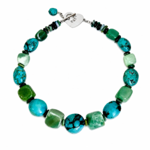“Handcrafted Aventurine Turquoise necklace featuring polished green and blue stones with natural veining and silver toggle clasp engraved ‘Caro.’”