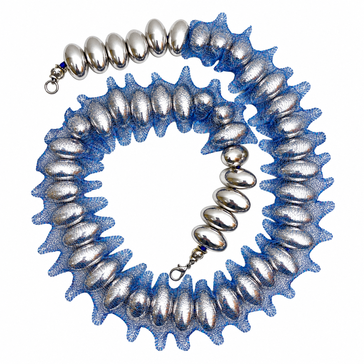 Photophore Necklace featuring large silver oval beads encased in shimmering blue metallic mesh with sculptural texture.