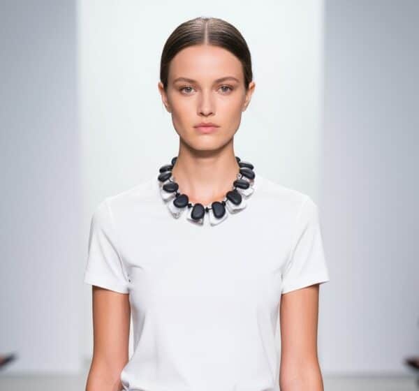 The Double Short Necklace is a bold statement piece featuring a double-strand design of large clear acrylic beads paired with matte black small beads. This modern aesthetic makes it versatile for both casual and formal wear, ensuring it stands out in any setting. Measuring 18 inches, the necklace includes an extension that adjusts up to 22 inches, allowing you to tailor the fit to your outfit and neckline. The double-strand design not only amplifies the visual impact but also adds structural strength, ensuring it drapes smoothly and maintains its shape. The striking contrast between transparent, chunky beads and sleek matte black accents creates an elegant yet contemporary look. Whether you style it solo over a crisp white shirt or layer it with other pieces for a more eclectic vibe, this necklace adapts effortlessly. Light enough for all-day wear yet substantial enough to elevate evening attire, the Double Short Necklace embodies modern sophistication. Its versatility makes it a must-have accessory that complements everything from minimalist ensembles to more elaborate outfits. With three subtle nods to its double-strand construction, this chunky necklace redefines refined edge. Add it to your collection for an instant refresh—versatility and impact, perfectly intertwined.