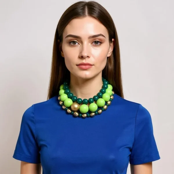 Color is the point here.  A blend of green tones.  Elevate your ensemble with this stunning triple-strand choker that captures the essence of verdant luxury. Crafted from a harmonious blend of forest green medium beads, vibrant lime green large beads, and delicate malachite green small beads, it weaves multiple shades into an irresistible tapestry. Each strand is elegantly interspersed with accent gold beads, adding a warm shimmer that complements the greens beautifully. Measuring 16 inches, this choker offers a snug yet comfortable fit at the base of the neck. Need extra reach? Simply extend to 20 inches for a more relaxed drape. Whether worn tight or slightly loose, this design adapts seamlessly to both casual and formal looks. The thoughtful arrangement showcases the full spectrum of leafy tones, offering a bold splash of emerald elegance. Its layered color structure creates depth and movement, ensuring you’ll catch light—and eyes—with every turn. Perfect for introducing a sophisticated pop of color without overwhelming your outfit, this piece stands out in a crowd. Ideal for pairing with a crisp white blouse or a sleek evening gown, the Exquisite Green Choker Necklace adds instant refinement. Embrace the splendor of greens and transform your look with this versatile accessory that celebrates nature’s richest hues.  Easily add a pop of color elegantly to any outfit.