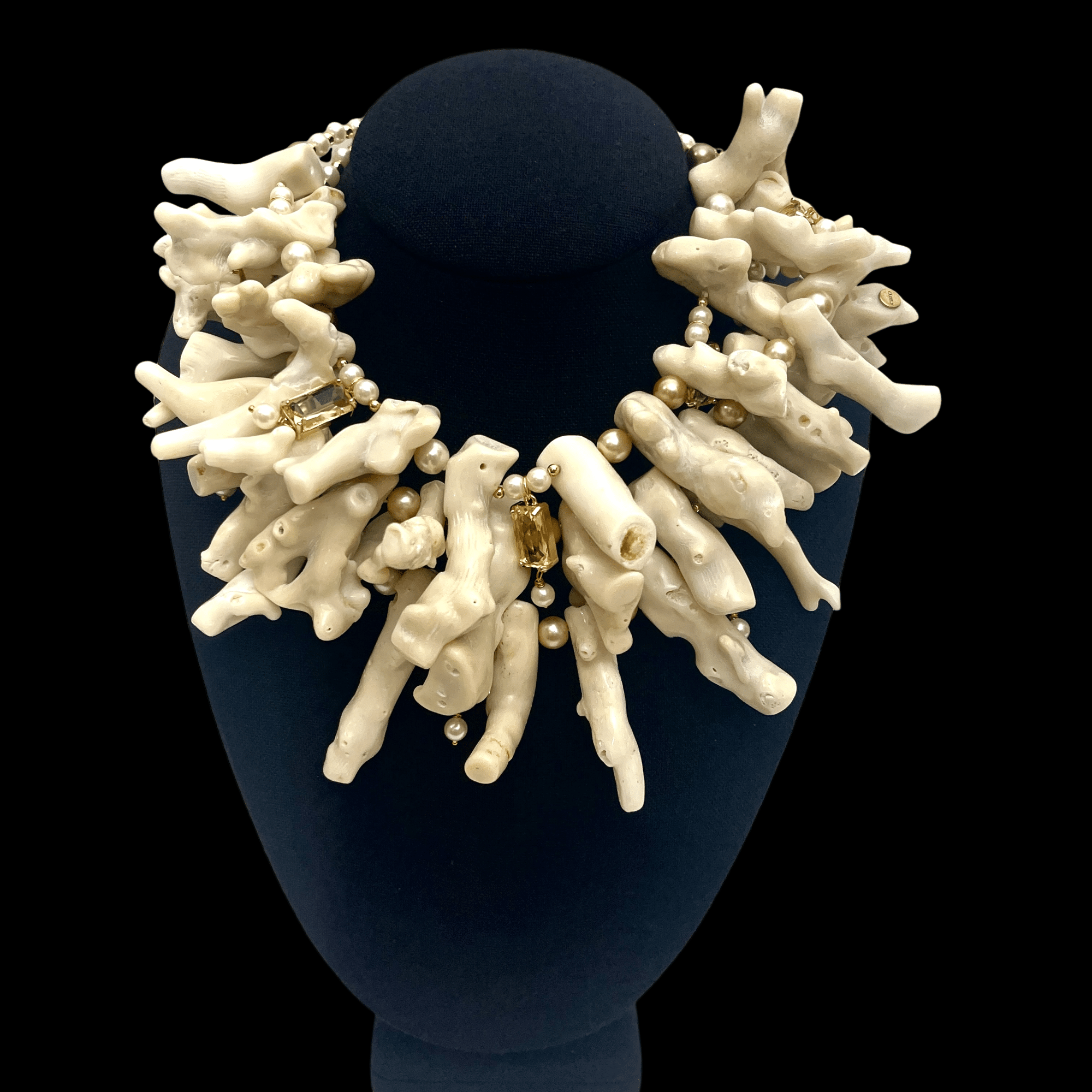Discover the timeless beauty of the Pola necklace, a handcrafted statement piece made from three strands of natural stick-type white coral. Accented with luminous pearls and soft yellow crystals, this design celebrates the organic textures and subtle tones of off-white coral, creating a look that’s both earthy and refined.