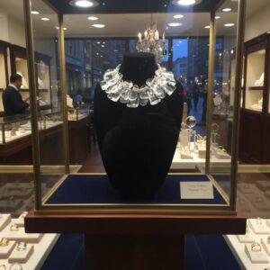 Clear Acrylic Cluster Necklace with Gold Accents Make a bold impression with this sculptural statement necklace, designed to evoke the crystalline beauty of ice.  Featuring a clustered arrangement of three strands of large, clear acrylic beads, this piece catches and reflects light with dazzling clarity.  Each bead is separated by gold-tone spacer accents, adding warmth and contrast to the cool, glass-like shimmer.   The necklace is secured with a large, easy-to-use lobster clasp, ensuring both comfort and durability. Measuring 17 inches in length with an adjustable extension up to 22 inches, it offers versatility for different necklines and styling preferences. At 16 ounces, it has a substantial feel—like wearing a piece of modern art. Whether you're dressing for a gallery opening, a winter soirée, or want to elevate your everyday look, this necklace will turn heads.  Its unique design mimics the elegance of ice formations, while the gold accents lend a touch of luxury.  This is more than jewelry—it’s a wearable sculpture, crafted to impress and inspire.  With its ice-like clarity and bold silhouette, it’s the perfect fusion of art and fashion.