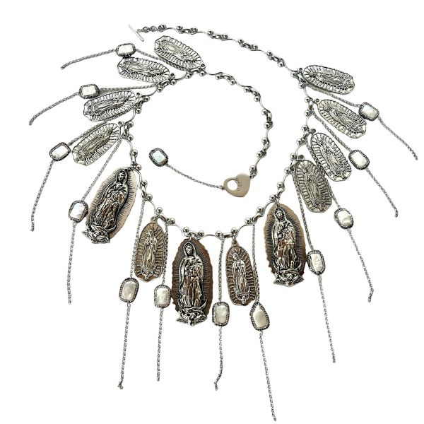 Reassurance Necklace Fierce elegance meets sacred rebellion. This 33-inch necklace is a visceral blend of armor and artistry. Heavy with intention at 14 oz, it drapes like a protective veil—layered silver-tone chains cascading with medallions that evoke mysticism and defiance. Fine threads of chain shimmer with freshwater pearls, softening the edge with quiet grace. Each element is chosen not just for beauty, but for symbolism: a chorus of metallic icons and sacred motifs that speak to resilience, identity, and unapologetic strength. Designed for those who walk the line between vulnerability and power, this piece commands attention. It pairs effortlessly with satin, leather, or bare skin—transforming any look into a statement. Whether worn solo or layered, it becomes a personal relic, a wearable manifesto. The Reassurance necklace doesn’t whisper. It roars. It’s for the ones who guard their hearts with style and speak their truth through adornment. It’s for the ones who know that protection can be beautiful, and beauty can be bold. Only one made. Details: Length: 33 inches Weight: 14 oz Materials: Silver-tone chain, freshwater pearls, mixed metal medallions Style: Rock & roll statement with symbolic depth Reassurance is not just jewelry. It’s armor with soul.