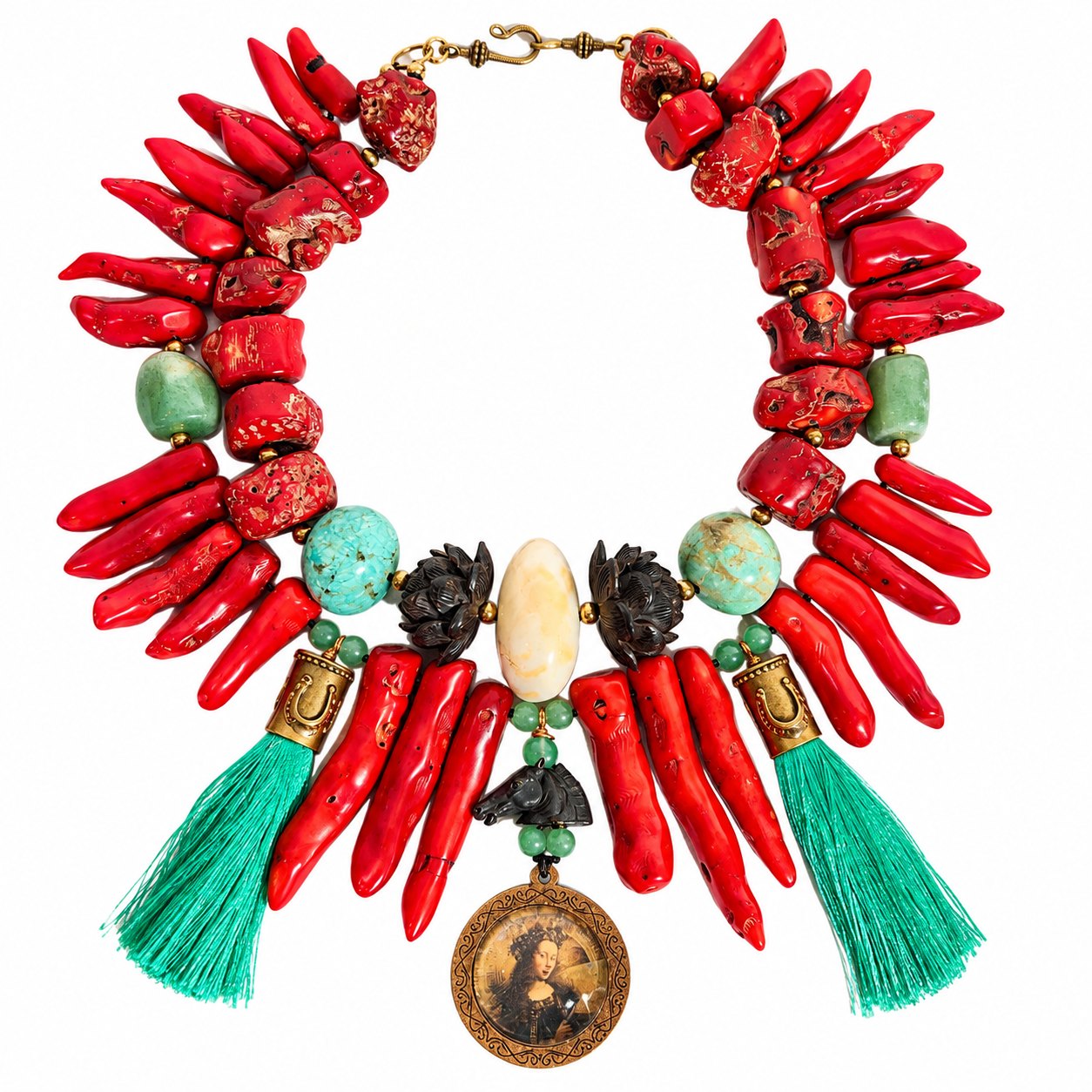 Handcrafted statement necklace featuring two strands of red coral—one raw and irregular, the other composed of elongated stick coral pieces. Accented with smooth green Amazonite and Agate stones, dark carved beads, and a central oval ivory-toned bead. The design includes teal tassels on each side and a round medallion pendant with a vintage portrait framed in bronze tones.