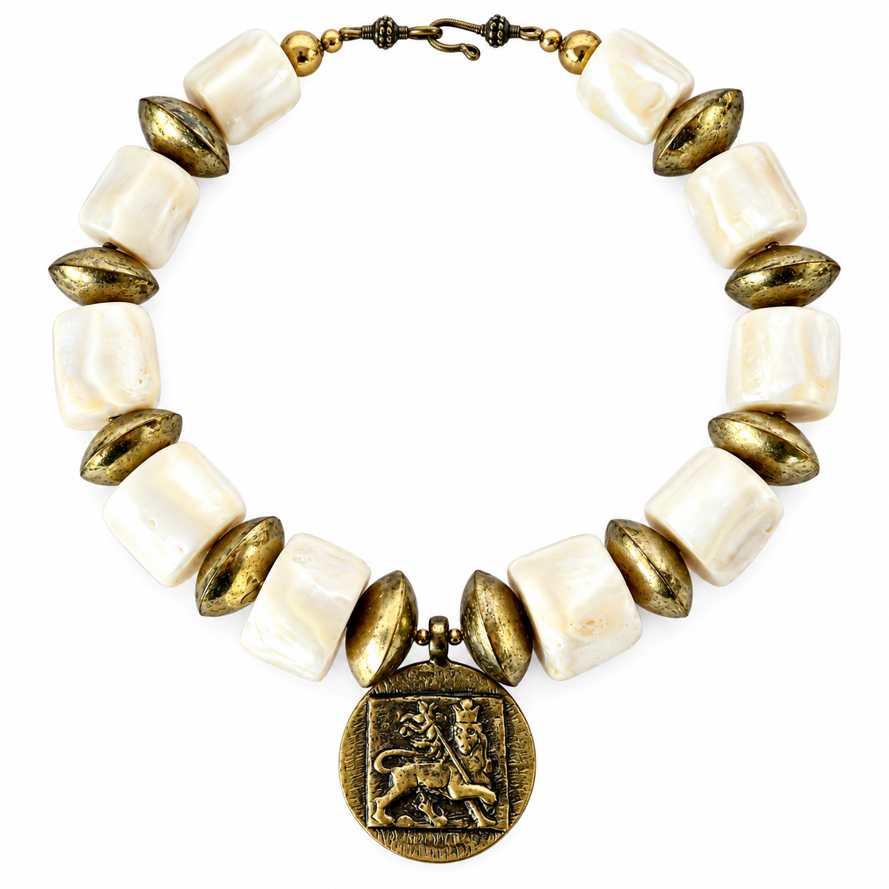 Statement necklace composed of alternating large square white coral beads and oval brass beads. At the center hangs a round brass medallion featuring a raised lion motif within a square frame, symbolizing strength and heritage. The necklace has a hook clasp with small decorative brass spheres.