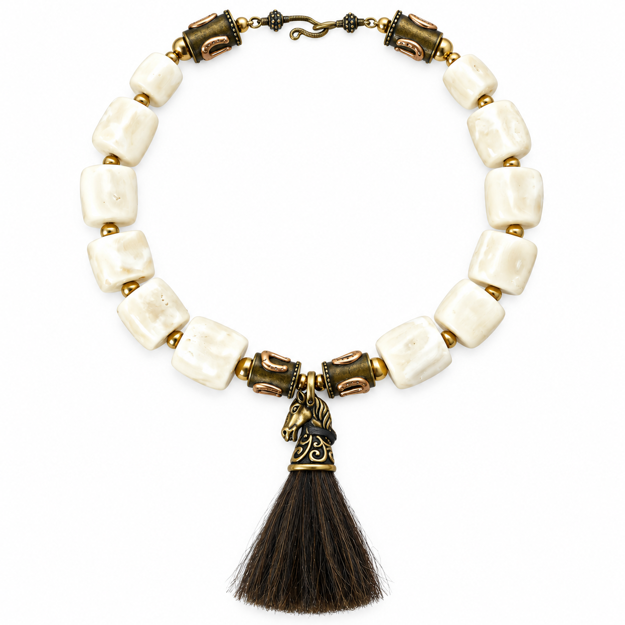 Equestrian-inspired necklace featuring large square white coral beads interspersed with brass spheres and cylindrical beads engraved with horseshoe motifs. At the center hangs a sculpted brass horse head pendant with intricate detailing, crowned by a dark horsehair tassel. The necklace closes with a hook clasp in antique brass finish.