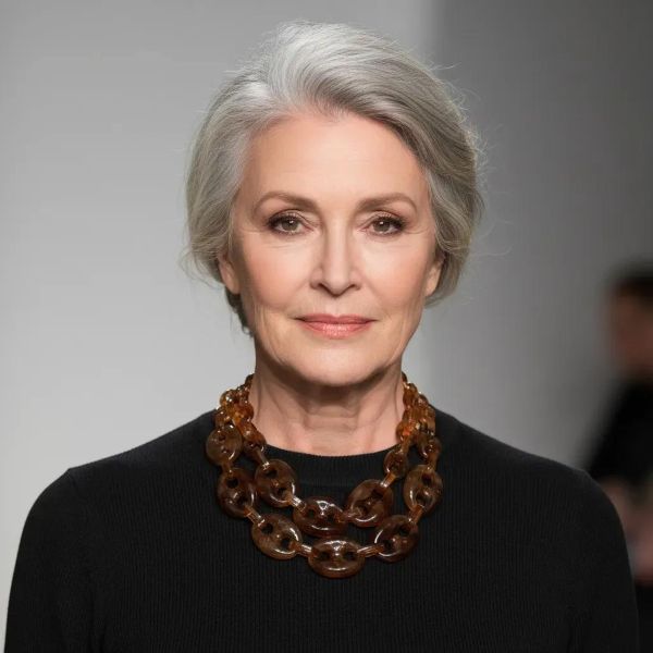 Revel Necklace Bold geometry. Glossy allure. Effortless drama. Crafted from oversized acrylic links, this double-strand necklace is a celebration of sculptural simplicity and modern edge. Each translucent loop catches the light with a tortoiseshell gleam, creating a rhythmic cascade of amber and espresso tones that feel both timeless and daring. At 18 inches, the necklace sits gracefully at the collarbone, with an extender allowing up to 20 inches for versatile styling. Despite its bold presence, it weighs a mere 4 ounces—light enough for all-day wear, yet substantial enough to make a statement. Revel in the interplay of texture and tone. Revel in the ease of pairing it with everything from crisp white shirts to plunging necklines. Revel in the confidence it inspires. Whether worn solo or layered with minimalist chains, this piece transforms any outfit into a curated look. It’s not just an accessory—it’s a mood, a moment, a magnet for compliments. Designed for those who embrace boldness with grace, this necklace invites you to step into your spotlight. Let the links speak for themselves, and let your style do the talking.