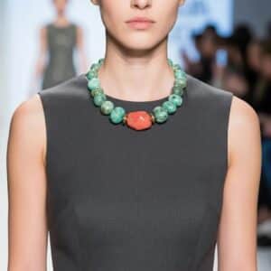 Amazon Necklace Rooted in nature. Radiant in spirit. This necklace is a tribute to the quiet power of simplicity. Crafted with natural amazonite beads in soft green-blue tones, it evokes the lush tranquility of riverbeds and forest canopies. At its heart lies a single coral stone—bold, warm, and unmistakably alive—anchoring the piece with a pulse of vibrant energy. Amazonite, known as the “stone of truth,” is celebrated for its calming influence and its ability to inspire honest expression. Its gentle hues mirror the serenity of the Amazon’s flowing waters, inviting clarity and emotional balance. The necklace’s 18-inch length, extendable to 23 inches, offers graceful drape and versatility, while its 8-ounce weight ensures a substantial yet comfortable presence. Natural coconut spacer beads add an earthy rhythm between the stones, enhancing the organic harmony of the design. A decorative clasp with gold-toned accents completes the look with artisanal finesse. Amazon is more than a name—it’s a feeling, a force, a connection to the wild and the wise. This necklace channels that essence, offering a wearable reminder of strength in softness and truth in simplicity. Let it be your companion in moments of reflection, expression, and quiet confidence.