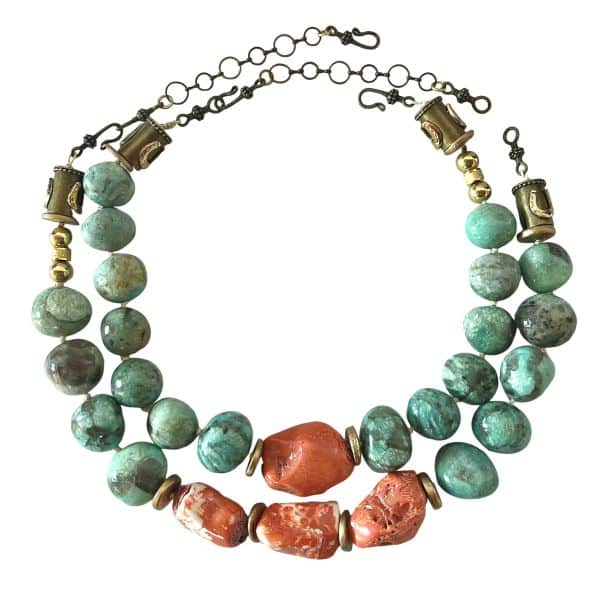 Amazonite Cluster Combo Layered color. Natural harmony. Effortless statement.   This Amazonite Cluster brings together two beautifully coordinated necklaces—products 0369242 and 0369243—designed to be worn as a striking layered duo or enjoyed individually. Each piece is crafted from natural amazonite, celebrated for its soothing blue‑green tones, and vibrant orange coral that adds a warm, energizing contrast. Gold‑accented coconut spacer beads introduce an earthy elegance, creating a balanced rhythm between color, texture, and shine. Both necklaces measure 18 inches in length and are fully adjustable, allowing you to achieve the perfect layered silhouette. When worn together, they create a bold, dimensional look that sits gracefully along the neckline. Combined, the two pieces weigh 14 ounces—substantial enough to feel luxurious, yet comfortable for all‑day wear. The Amazonite Cluster is ideal for those who love versatility. Wear the full combo for a dramatic, curated statement, or separate the pieces to suit your mood, outfit, or occasion. Each necklace stands beautifully on its own, yet together they form a cohesive, artful pairing that elevates any style. Whether you’re drawn to the calming presence of amazonite, the fiery charm of coral, or the richness of layered design, this combo offers endless ways to express your individuality.  You can purchase either piece separately by searching for the product number, or purchase this combo at a lower price.