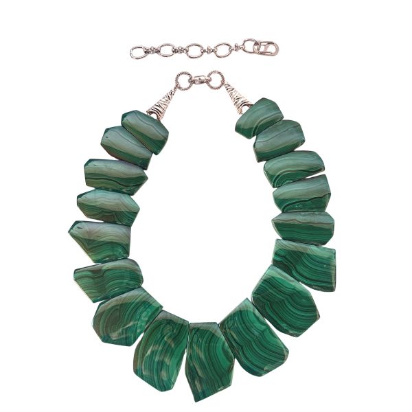 Verdant Malachite Statement Necklace A bold expression of Earth’s artistry and ancient mineral lore. This striking necklace showcases a curated arrangement of polished malachite stones, each one revealing the mesmerizing Concentric banding that makes this mineral so instantly recognizable.