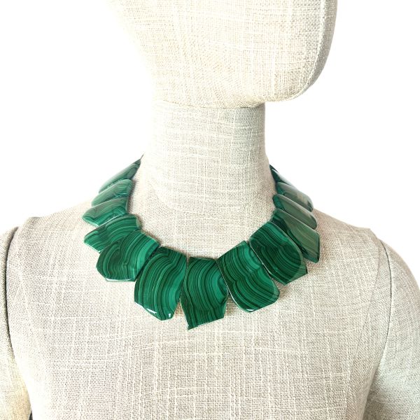 Verdant Malachite Statement Necklace A bold expression of Earth’s artistry and ancient mineral lore. This striking necklace showcases a curated arrangement of polished malachite stones, each one revealing the mesmerizing Concentric banding that makes this mineral so instantly recognizable.