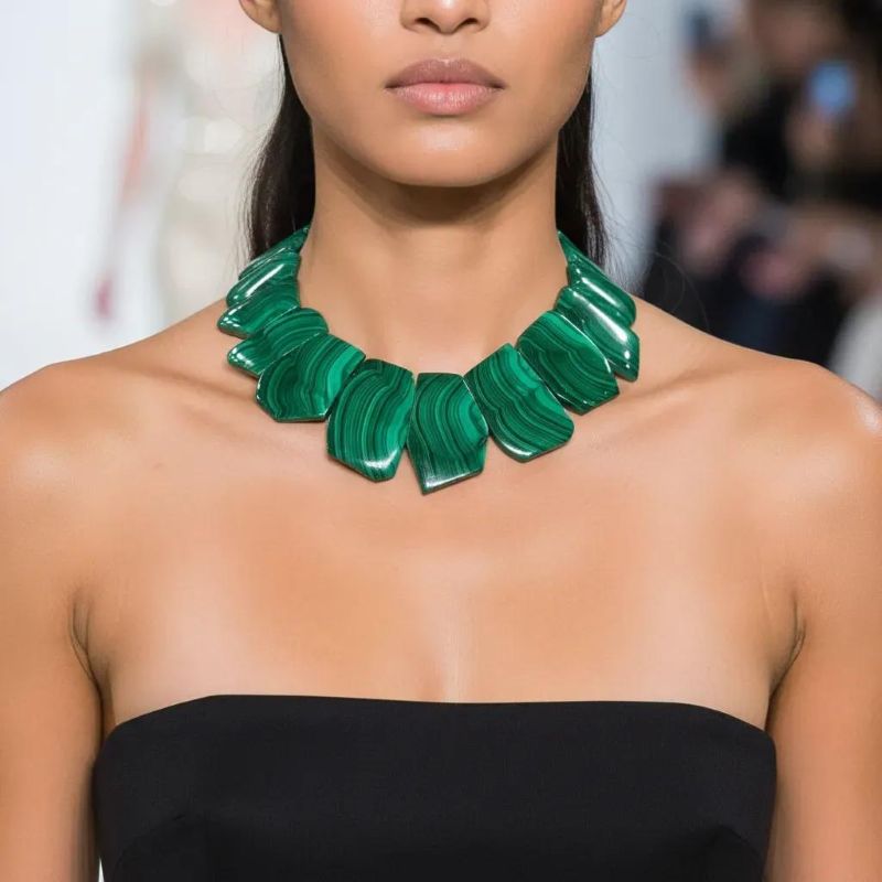 Verdant Malachite Statement Necklace A bold expression of Earth’s artistry and ancient mineral lore. This striking necklace showcases a curated arrangement of polished malachite stones, each one revealing the mesmerizing Concentric banding that makes this mineral so instantly recognizable.