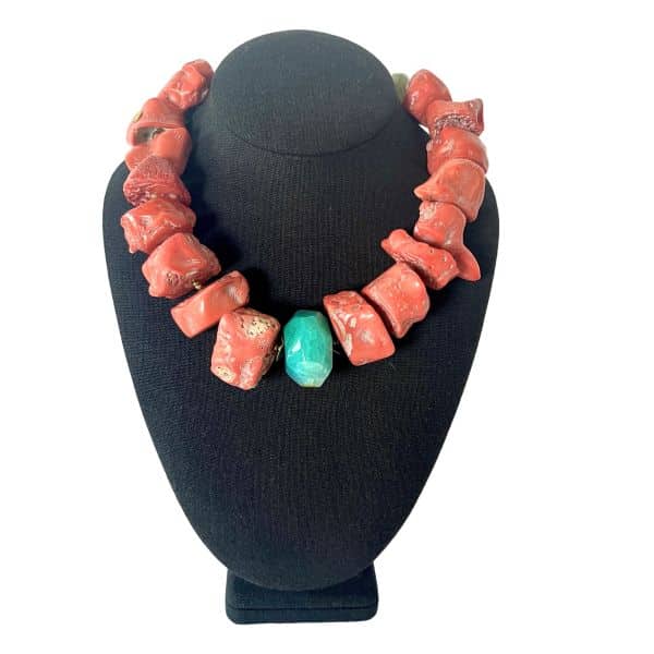 **Dragon’s Back 0369257 – Natural Coral & Green Agate Choker Necklace** A bold fusion of natural texture and vibrant color defines *Dragon’s Back 0369257*, a short choker‑length necklace designed to sit gracefully at the base of the neck. Crafted from large, organically shaped natural coral beads, the piece showcases rich, earthy reds that feel both powerful and timeless. Smooth green Agate accent beads introduce a refreshing contrast, adding depth and balance to the composition while enhancing the necklace’s sculptural silhouette. The name pays homage to the dramatic ridge‑like arrangement of the stones, evoking the mythical strength of the **Dragon's Back** without overwhelming the design. Measuring 19 inches with an extender that allows up to 22 inches, this necklace offers a flexible fit that adapts to a variety of necklines. At 12 ounces, it has a substantial presence that remains comfortable for everyday wear or special occasions. Natural coral has long been admired for its organic beauty and symbolic meaning. Historically, coral has been associated with protection, vitality, and good fortune, and its formation over thousands of years makes each bead a small geological treasure. These qualities enrich the story behind the piece, giving it a sense of heritage and connection to the natural world. The **Dragon's Back** spirit woven into the design enhances its bold character, while the interplay of coral and Agate creates a harmonious, eye‑catching finish. This necklace is ideal for collectors who appreciate artistry, symbolism, and the quiet power of natural materials, making it a standout addition to any jewelry collection that celebrates the mystique of the **Dragon**.