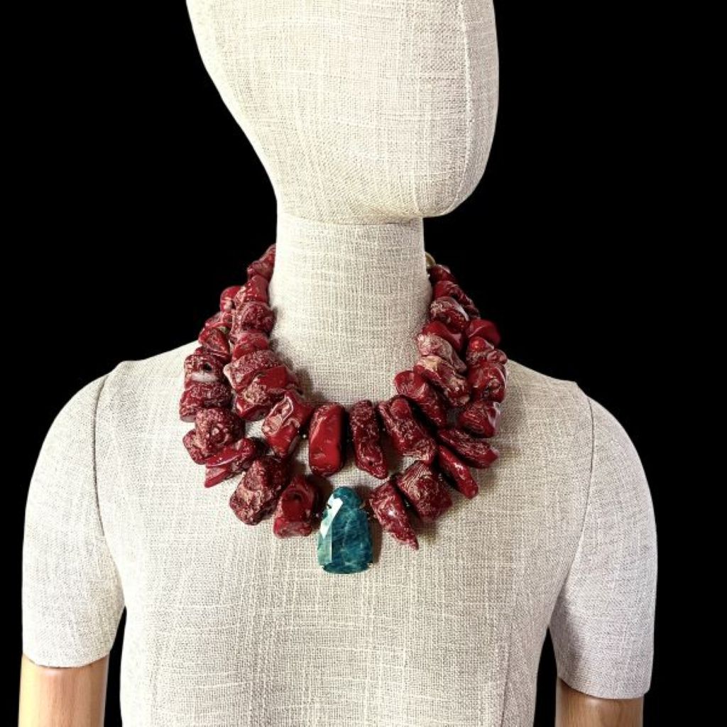 “Bold red two‑strand coral necklace with Apatite centerpiece displayed on a neutral background.”