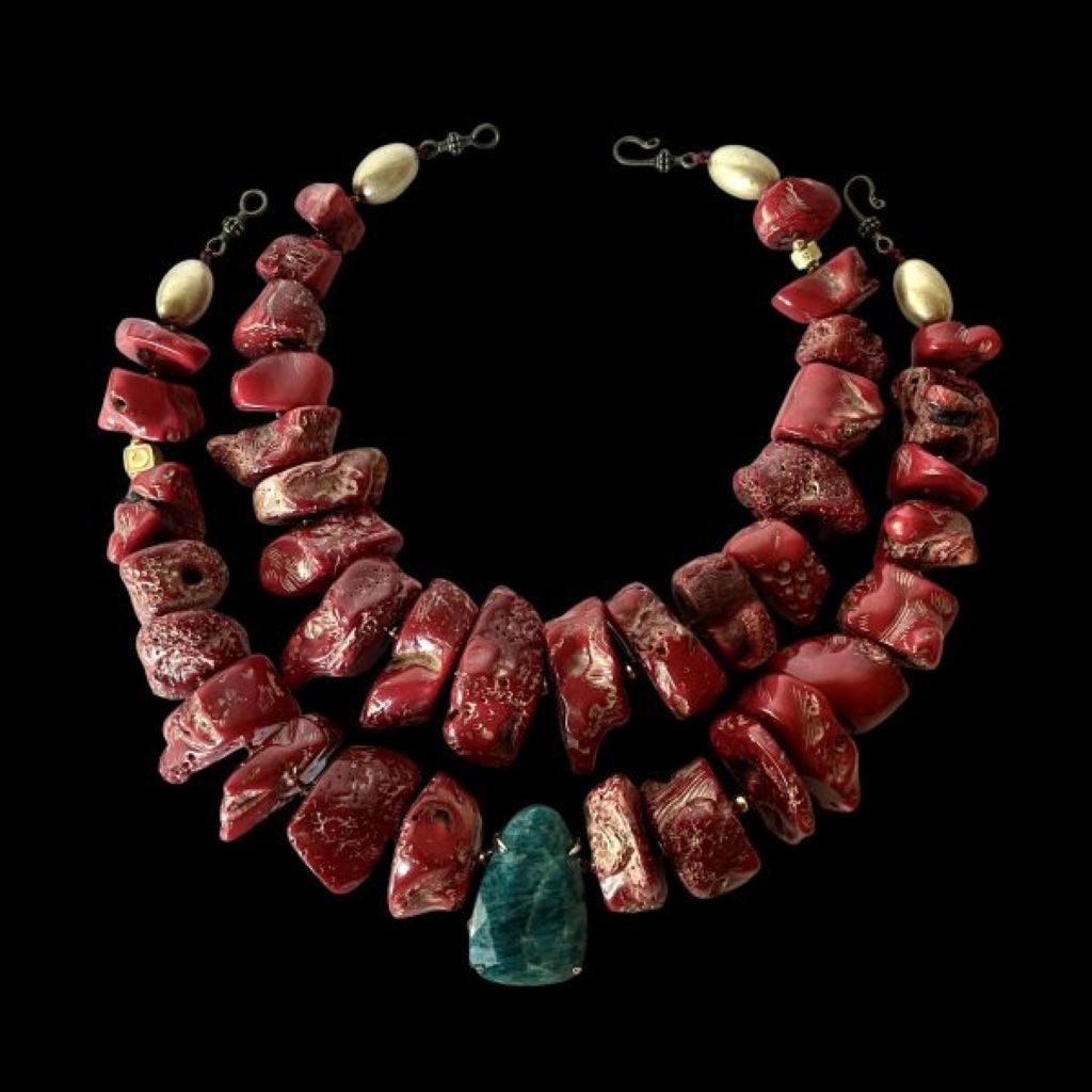 “Bold red two‑strand coral necklace with Apatite centerpiece displayed on a neutral background.”